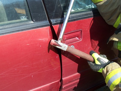 Pry Axe creating an opening in a car door picture